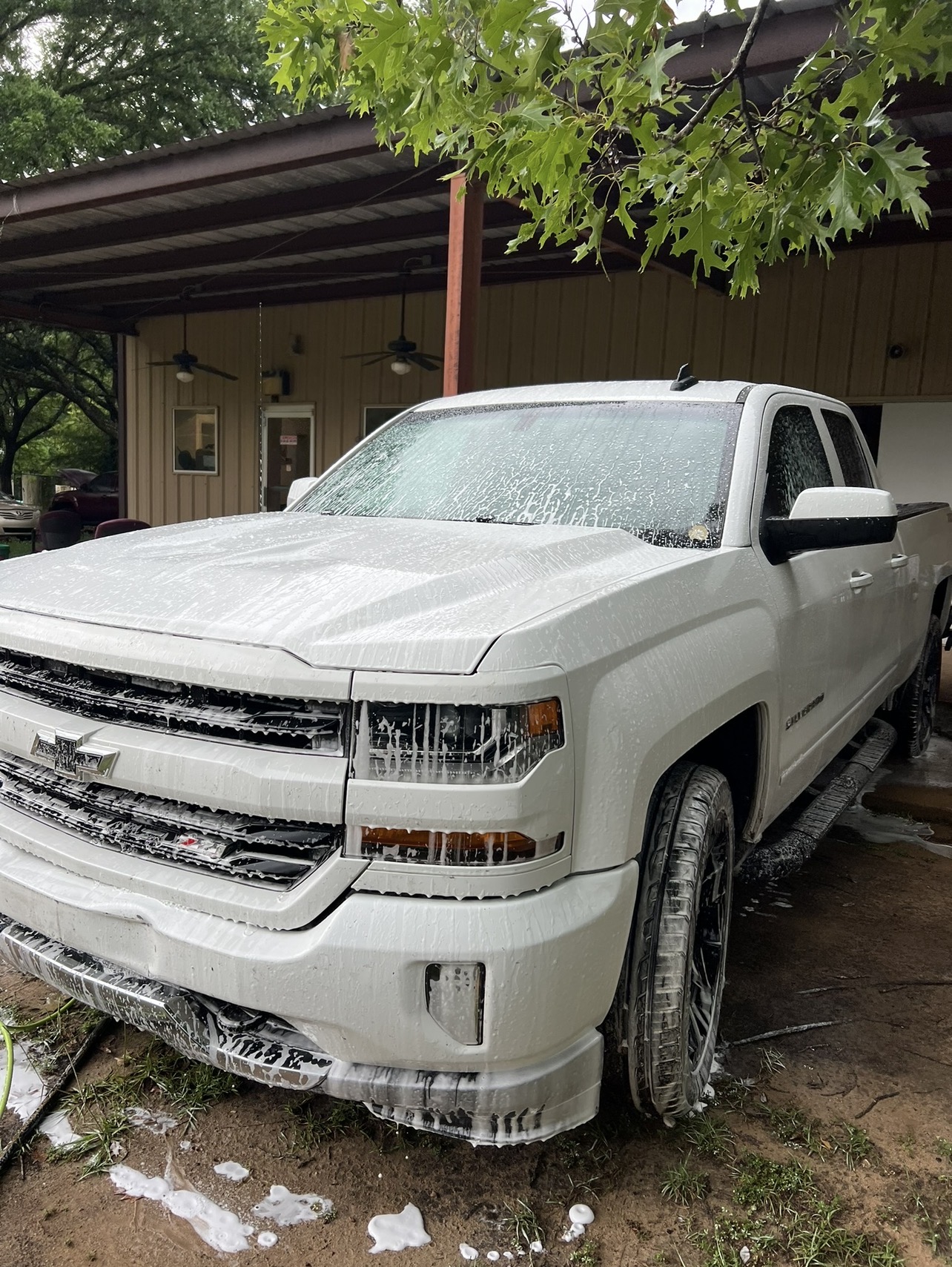Foam wash on a white Chevy Silverado